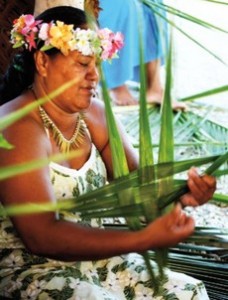Mama tressant un panier en Coco